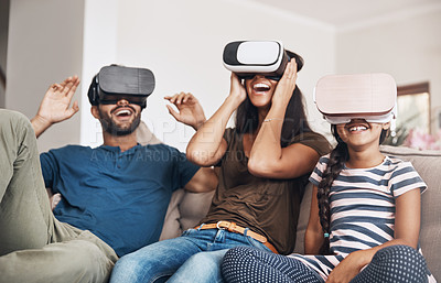 Buy stock photo Shot of a young family using virtual reality headsets together at home