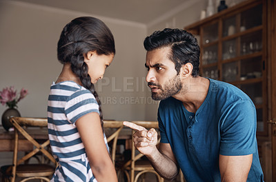 Buy stock photo Shot of a father disciplining his daughter at home