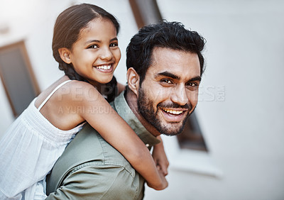 Buy stock photo Shot of a happy father and daughter enjoying a piggyback ride together outdoors