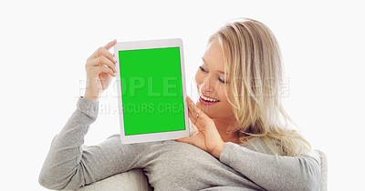 Buy stock photo Shot of an attractive young woman holding up a tablet at home