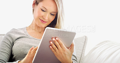 Buy stock photo Cropped shot of an attractive young woman using a tablet in her home