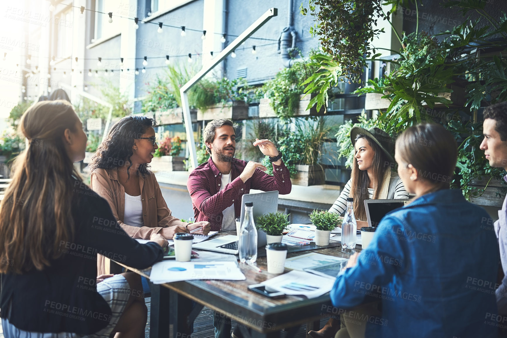 Buy stock photo Shot of a group of designers having a meeting at a coffee shop