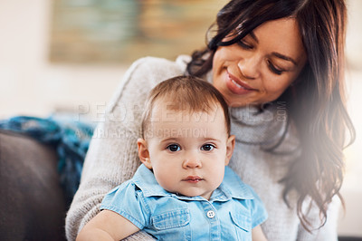 Buy stock photo Shot of an adorable baby girl bonding with her mother on the sofa at home