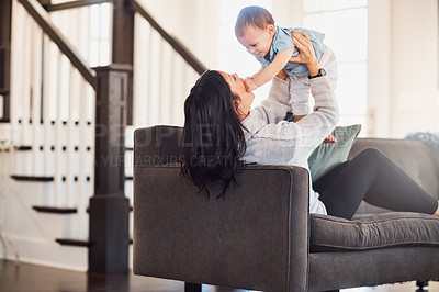 Buy stock photo Shot of an adorable baby girl bonding with her mother on the sofa at home