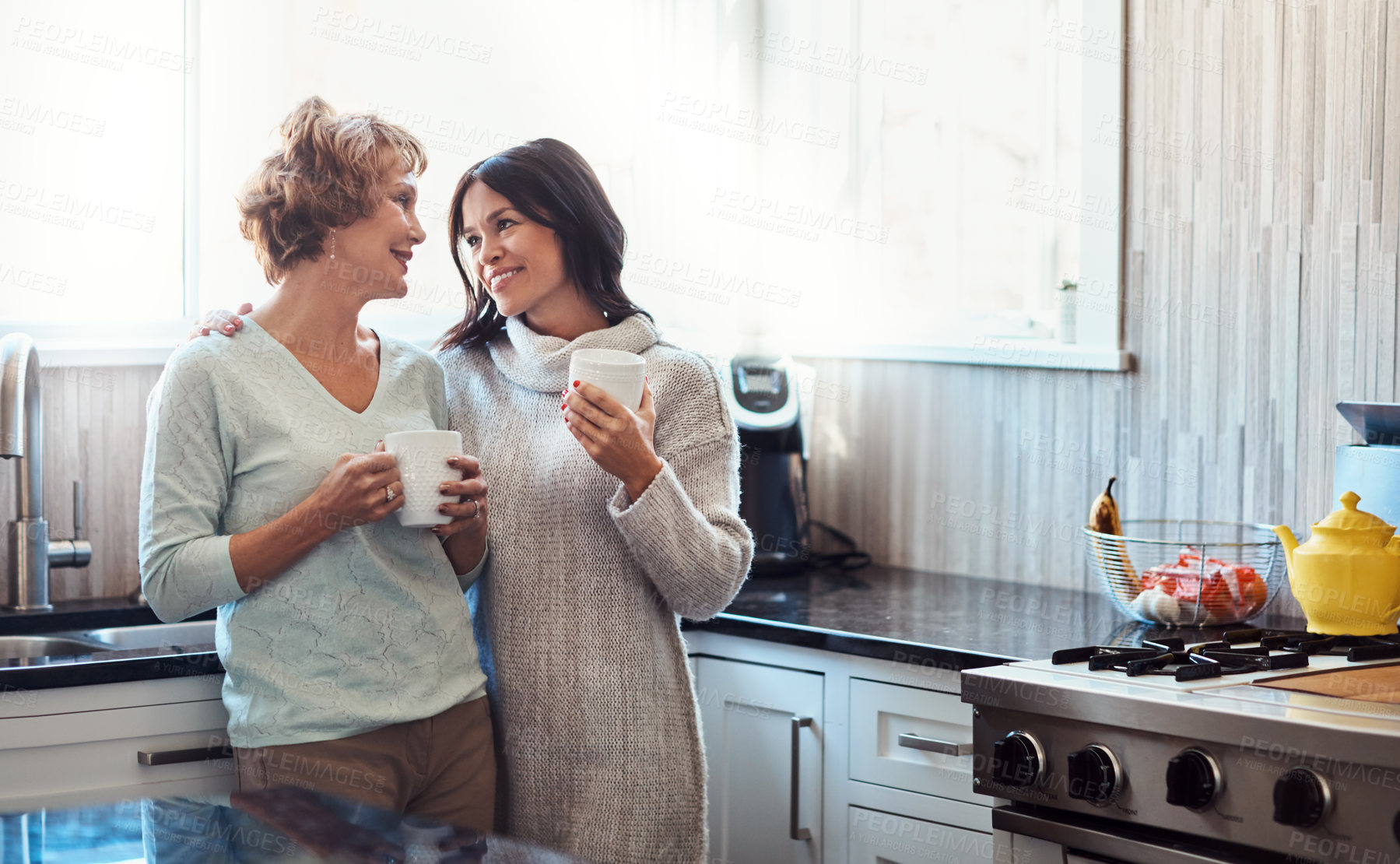 Buy stock photo Love, hug and woman with senior mother in kitchen for coffee, bonding and support on weekend visit at home. Family, conversation and girl with elderly mom in house for speaking, comfort or trust