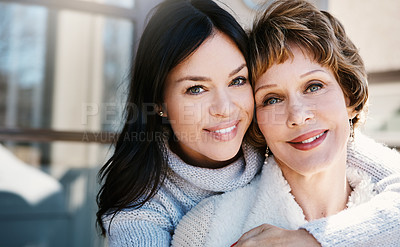 Buy stock photo Shot of a happy young woman spending quality time with her mother