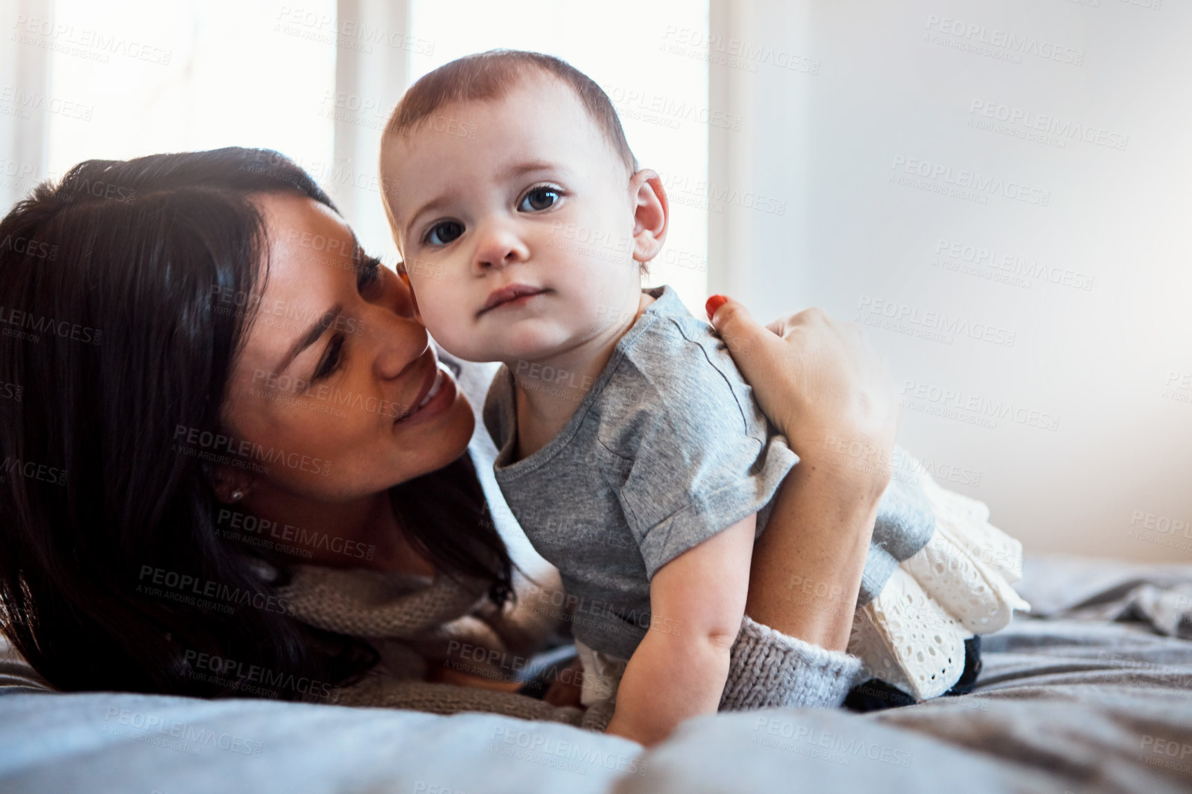 Buy stock photo Shot of an adorable baby girl bonding with her mother at home