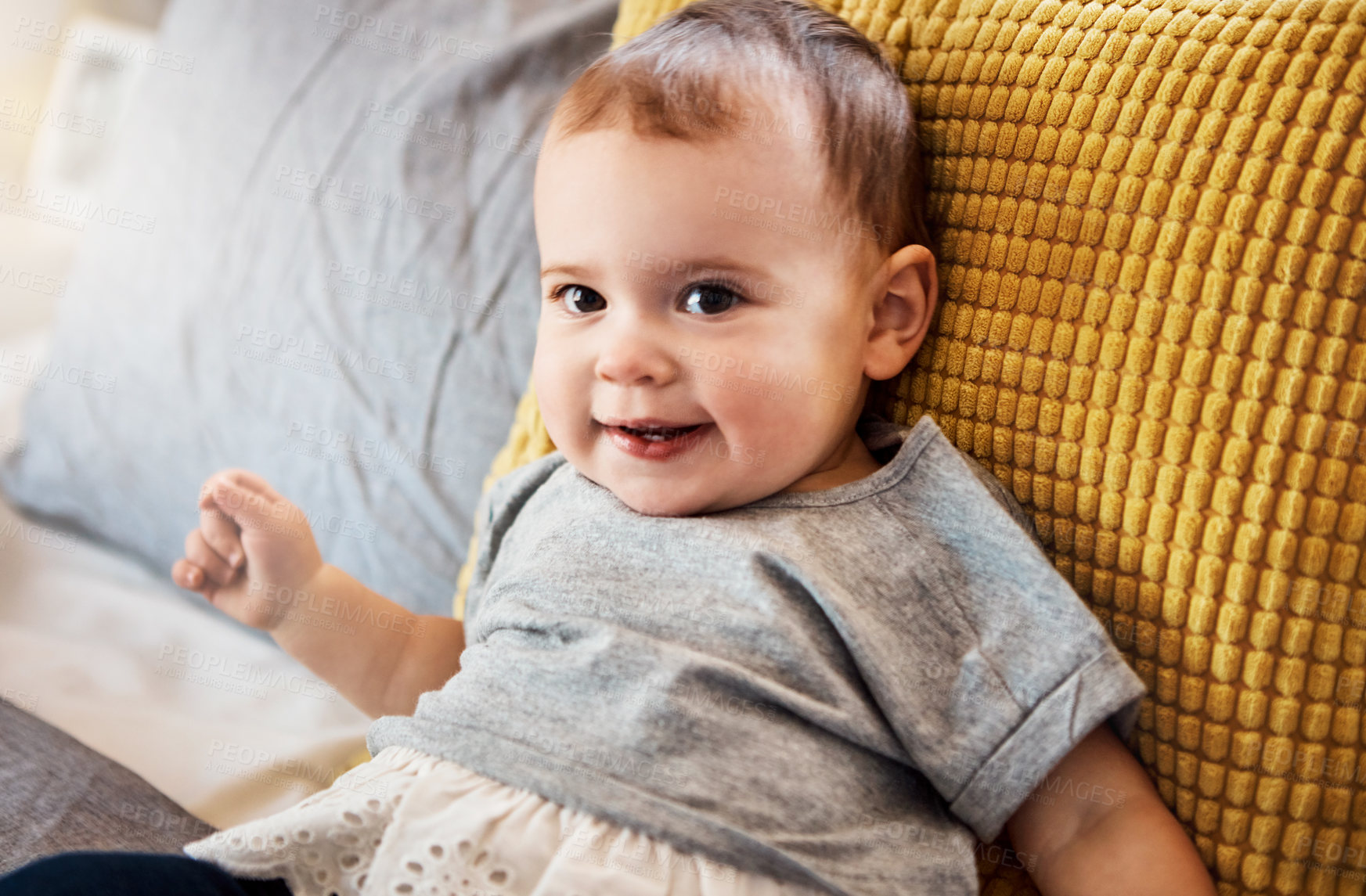 Buy stock photo Portrait of an adorable baby girl relaxing on the bed at home