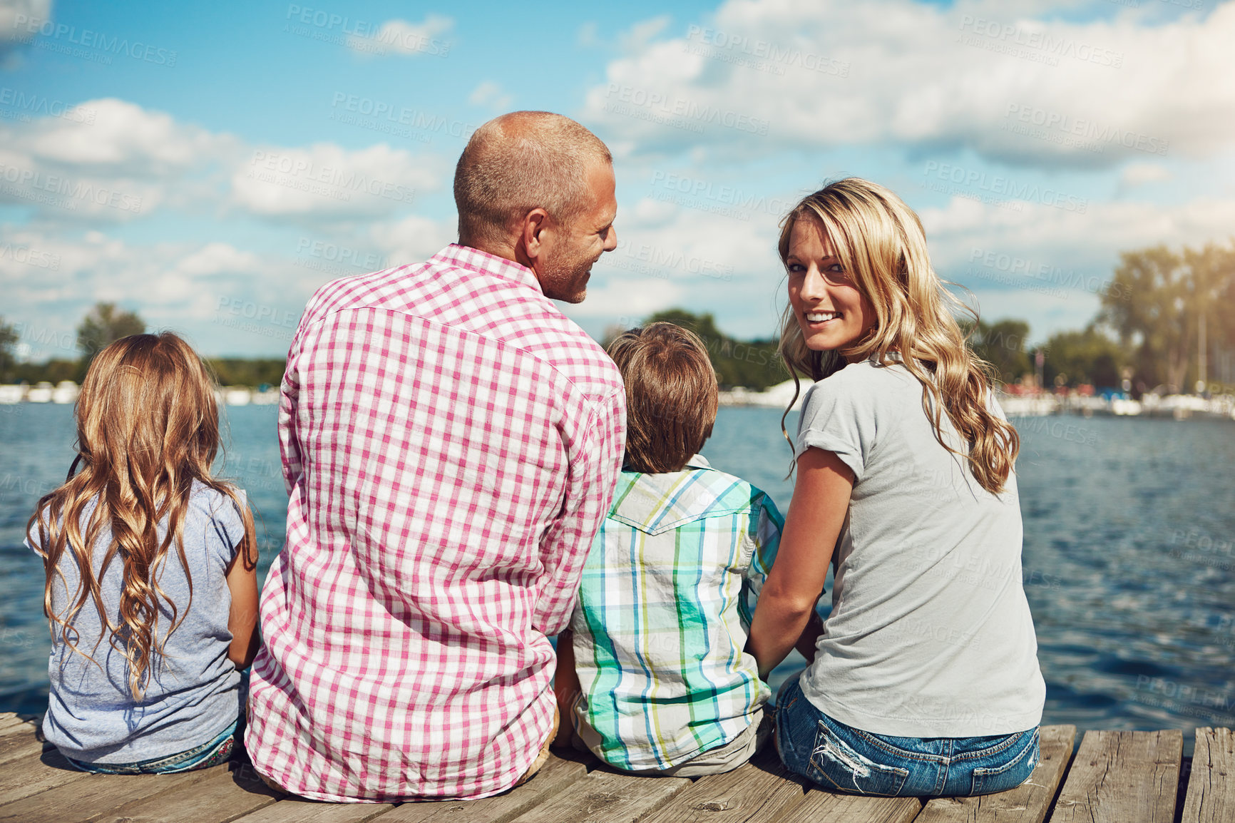 Buy stock photo Family, lake and portrait on vacation dock, peace and travel to relax by water together. Parents, children and love on holiday by river or care in nature, bonding and outdoor for relationship on pier