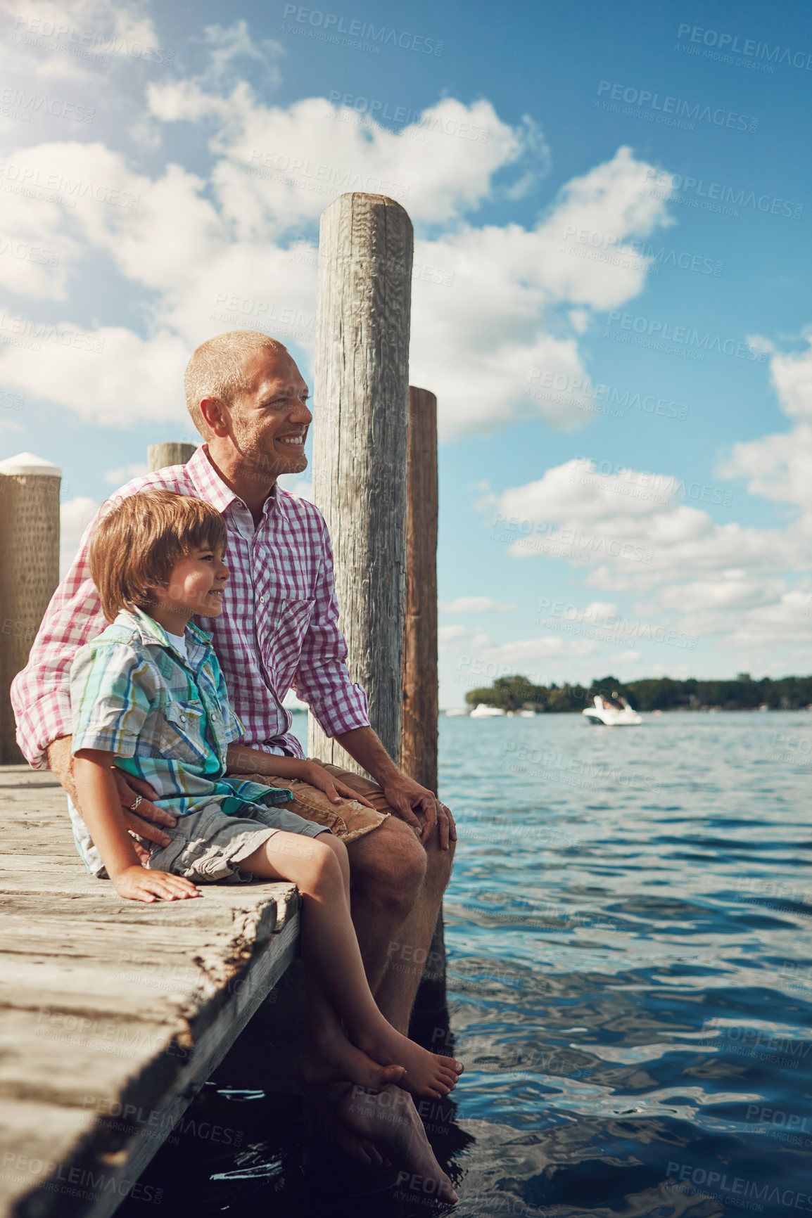 Buy stock photo Pier, relax and father with kid at lake for holiday, getaway or weekend trip with bonding. Happy, dock and dad with boy child by river water for connection, care and family time on summer vacation.