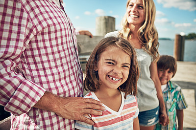 Buy stock photo Shot of a young family on a pier while out by the lake