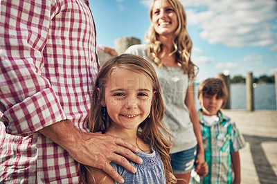 Buy stock photo Shot of a young family on a pier while out by the lake