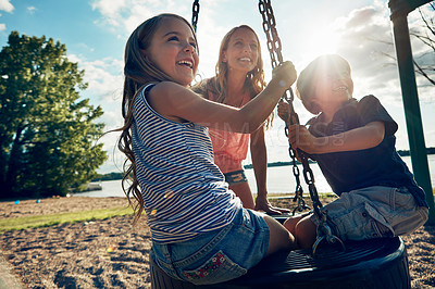 Buy stock photo Playground, swing and sunshine with mama, kids and excited with happiness, summer and bonding together. Family, single parent and woman with son, daughter and childhood with games, fun or vacation