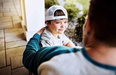 Buy stock photo Rearview shot of a father and his son bonding on their porch at home