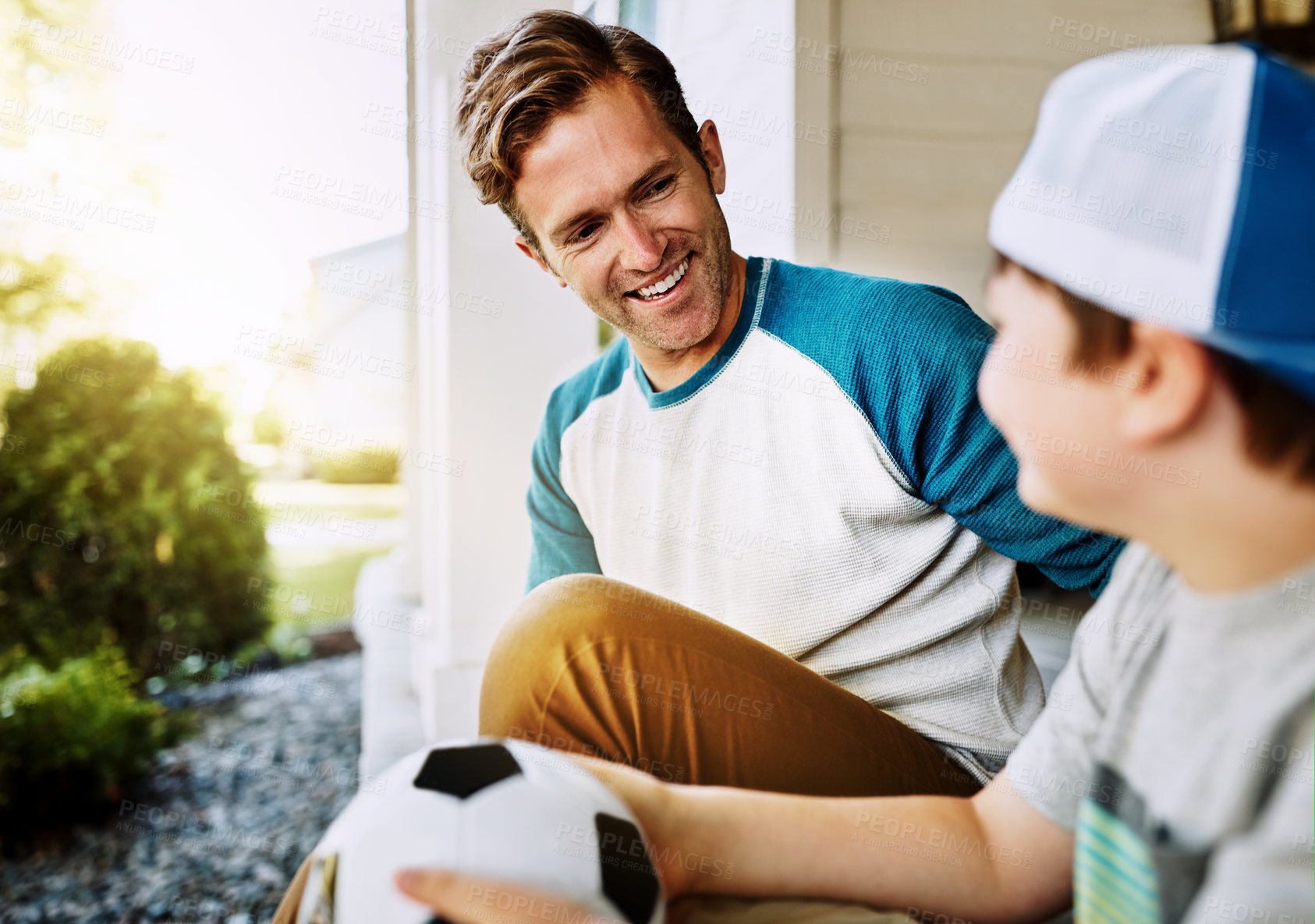 Buy stock photo Happy, kid and dad with soccer ball by home for outdoor sports, bonding and conversation on weekend. Smile, man and son outside house with love for exercise, practice and break on fathers day