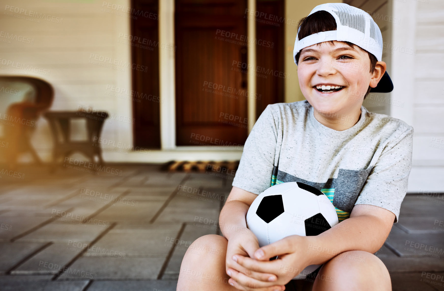 Buy stock photo Children, laugh and funny boy on a porch with soccer ball for summer camp, learning and sports. Face, smile and kid with football outdoor for bootcamp, training or weekend games, development or home