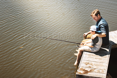 Buy stock photo Shot of a father and his little son fishing together