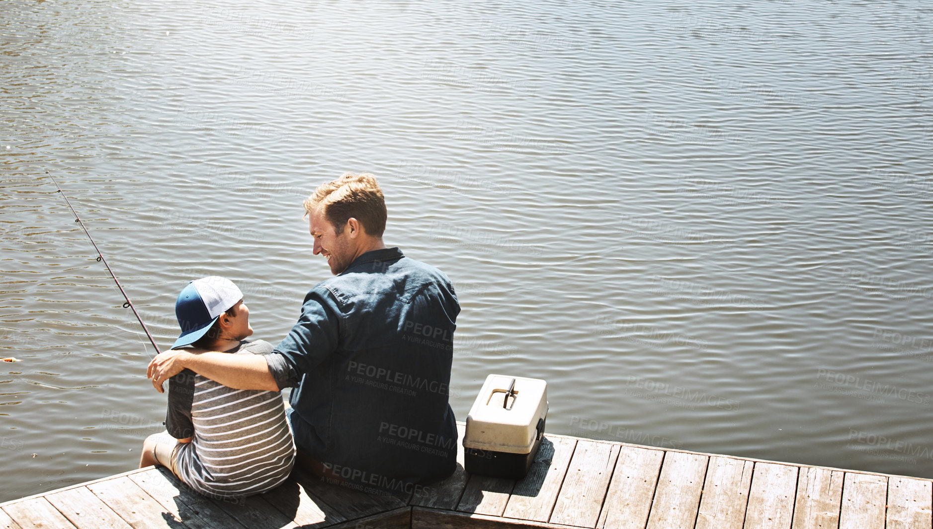 Buy stock photo Fishing, lake and father hug child in nature for teaching skill, adventure and vacation together outdoors. Family, happy and dad with young boy by river with rod for sports, hobby and catch fish