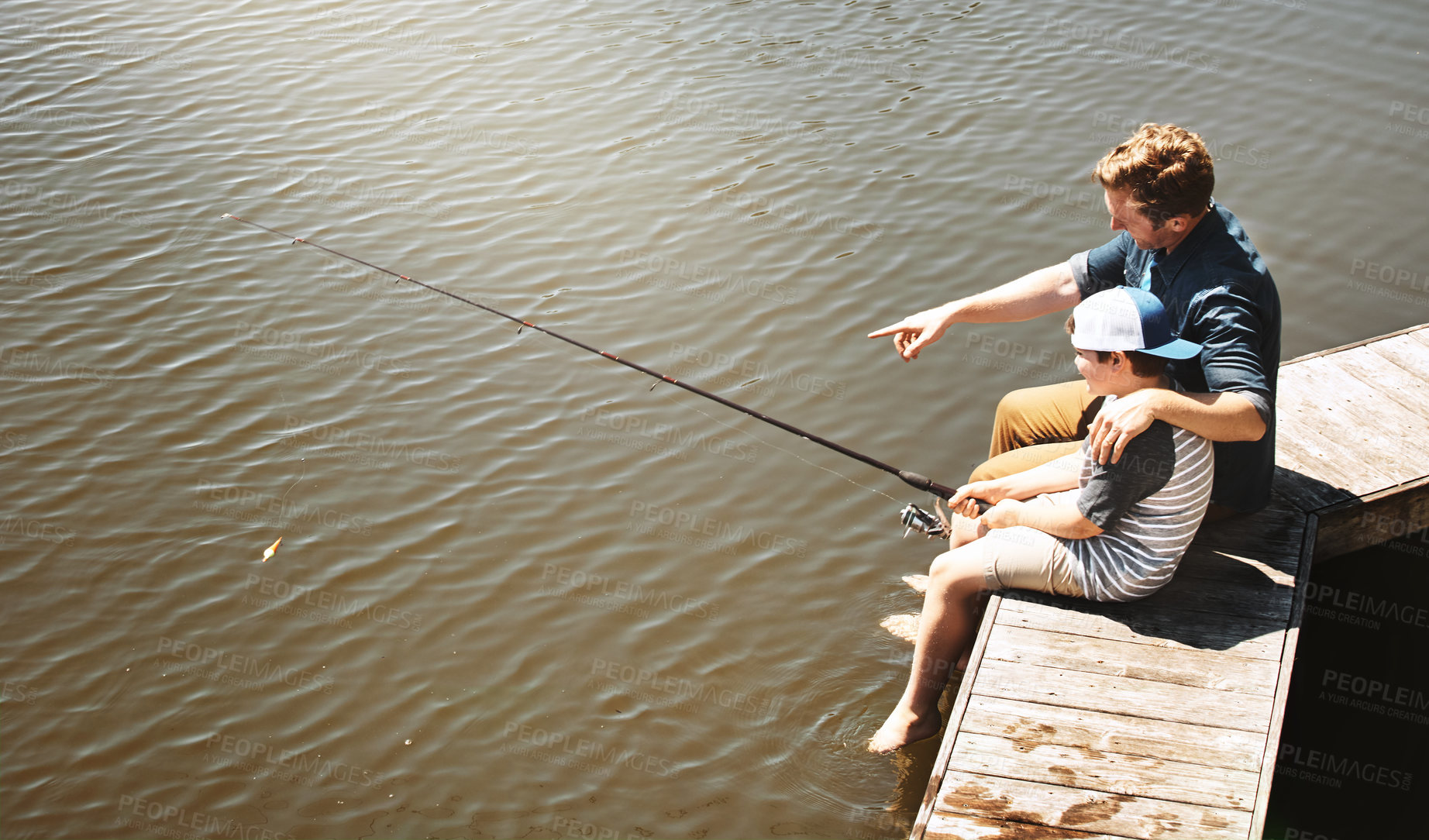 Buy stock photo Fishing, lake and dad with child in nature for teaching skill, adventure and vacation together outdoors. Family, happy and father with young boy by river with rod for sports, hobby and catch fish