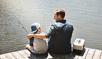 Buy stock photo Happy father, back view and fishing with son or rod by beach, lake or ocean in nature. Dad with child, kid or little boy enjoying bonding, lesson or tips to catch sea creatures with hug by water