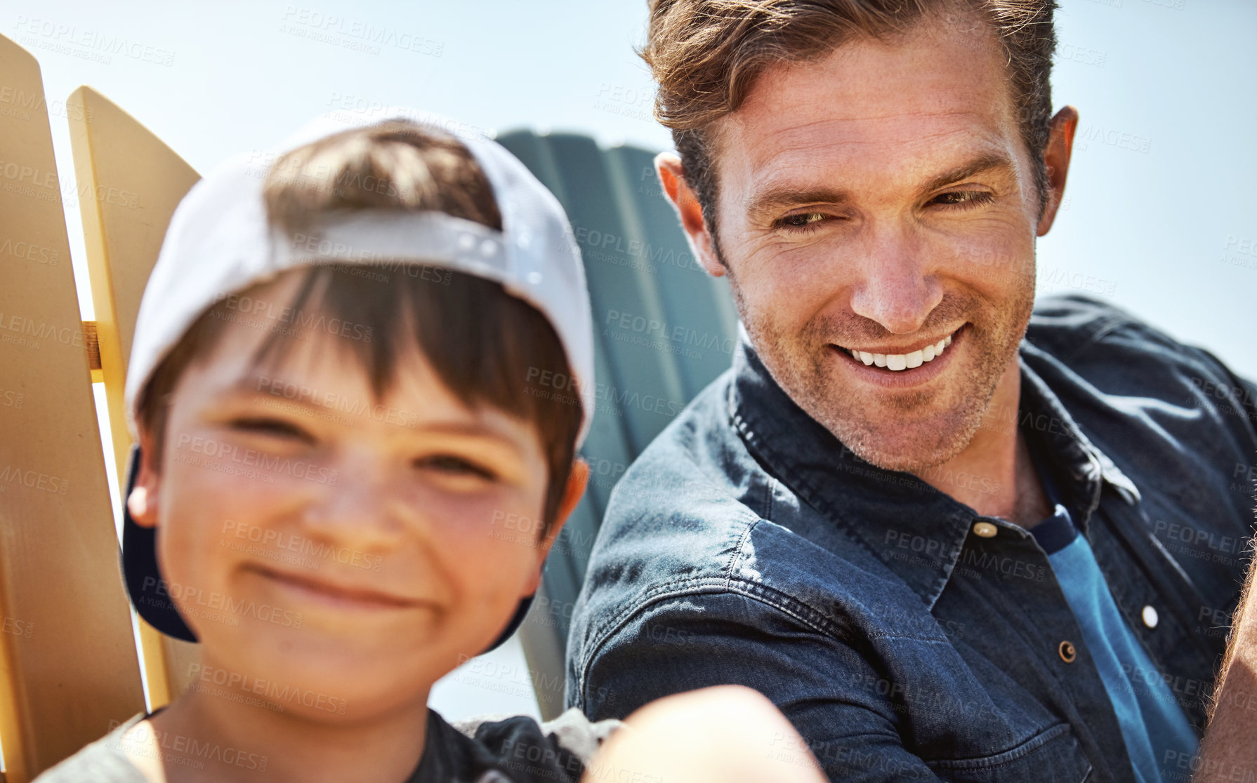 Buy stock photo Portrait of a little boy bonding with his father outdoors