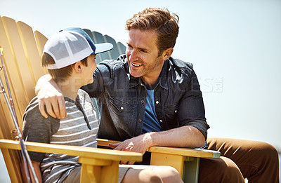 Buy stock photo Shot of a father bonding with his little son outdoors