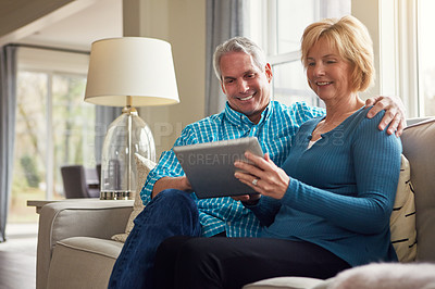 Buy stock photo Senior couple, tablet and smile on sofa for reading, decision or search on web in home living room. Old man, elderly woman and happy for choice on app for video, streaming and movie on couch in house