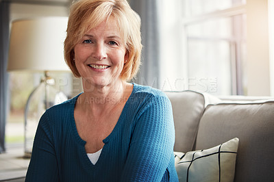 Buy stock photo Portrait of a happy mature woman relaxing on the sofa at home