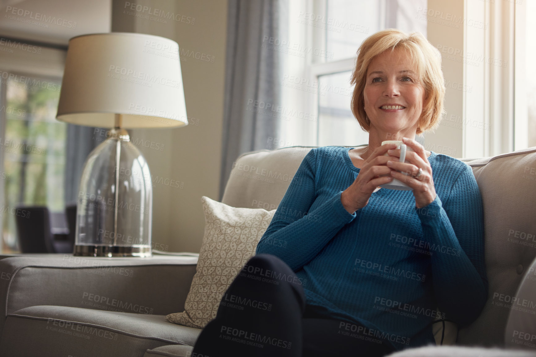 Buy stock photo Thinking, smile and senior woman on sofa with coffee, relax and nostalgic morning reflection at home. Remember, calm and elderly female person with tea break in living room for peace, memory or pride