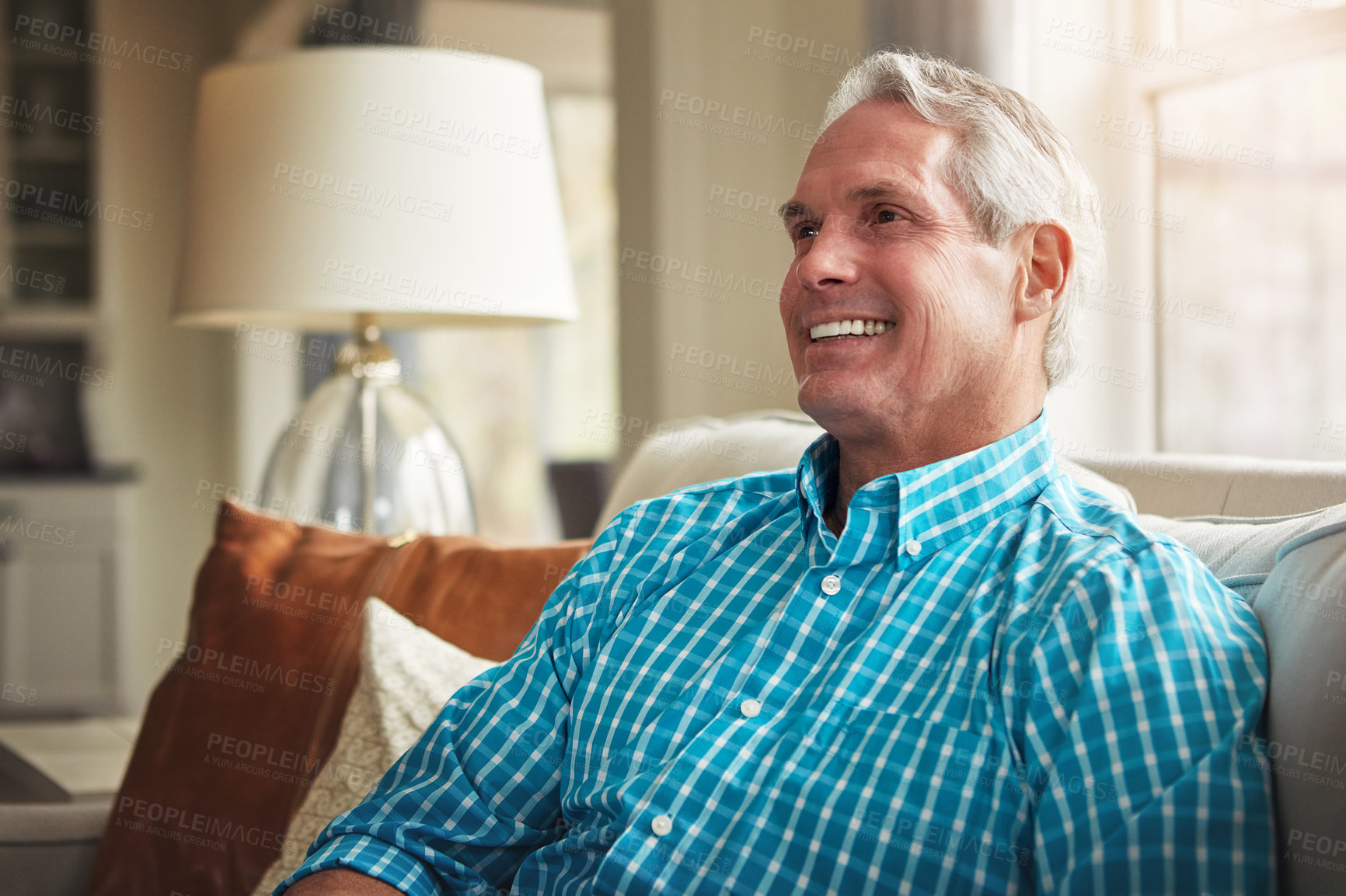 Buy stock photo Shot of a happy mature man relaxing on the sofa at home