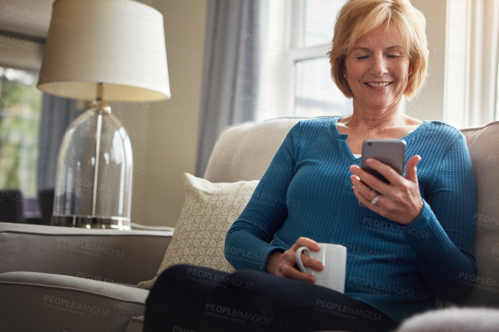 Buy stock photo House, coffee and old woman on sofa with smartphone, typing or connection with social media in lounge. Happy senior person, apartment or mature lady with cellphone, internet or relax with digital app