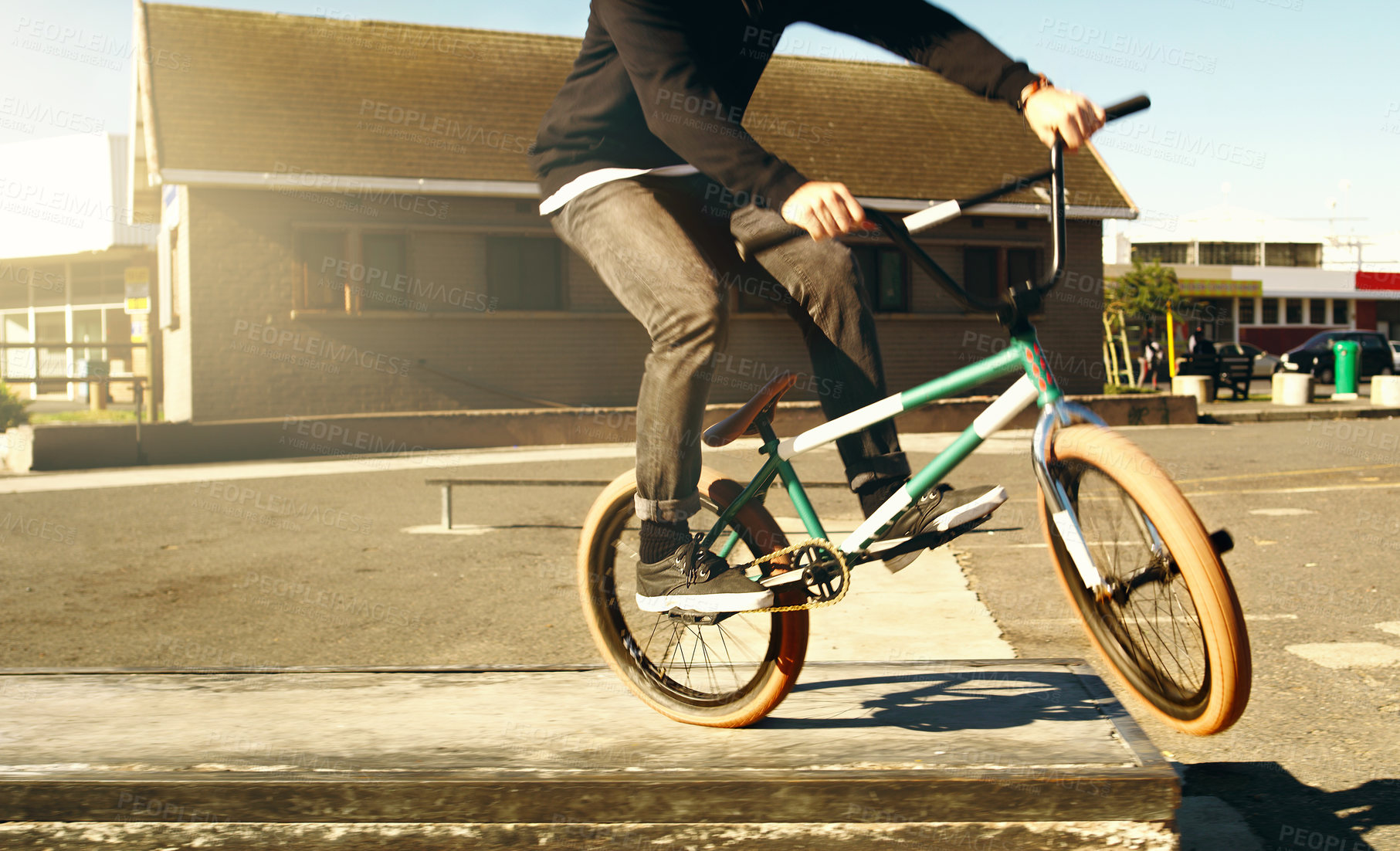 Buy stock photo Cropped shot of an unrecognizable male BMX biker doing tricks outside