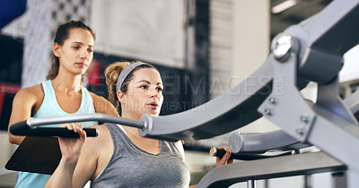 Buy stock photo Cropped shot of a female fitness instructor taking her client through a workout in the gym