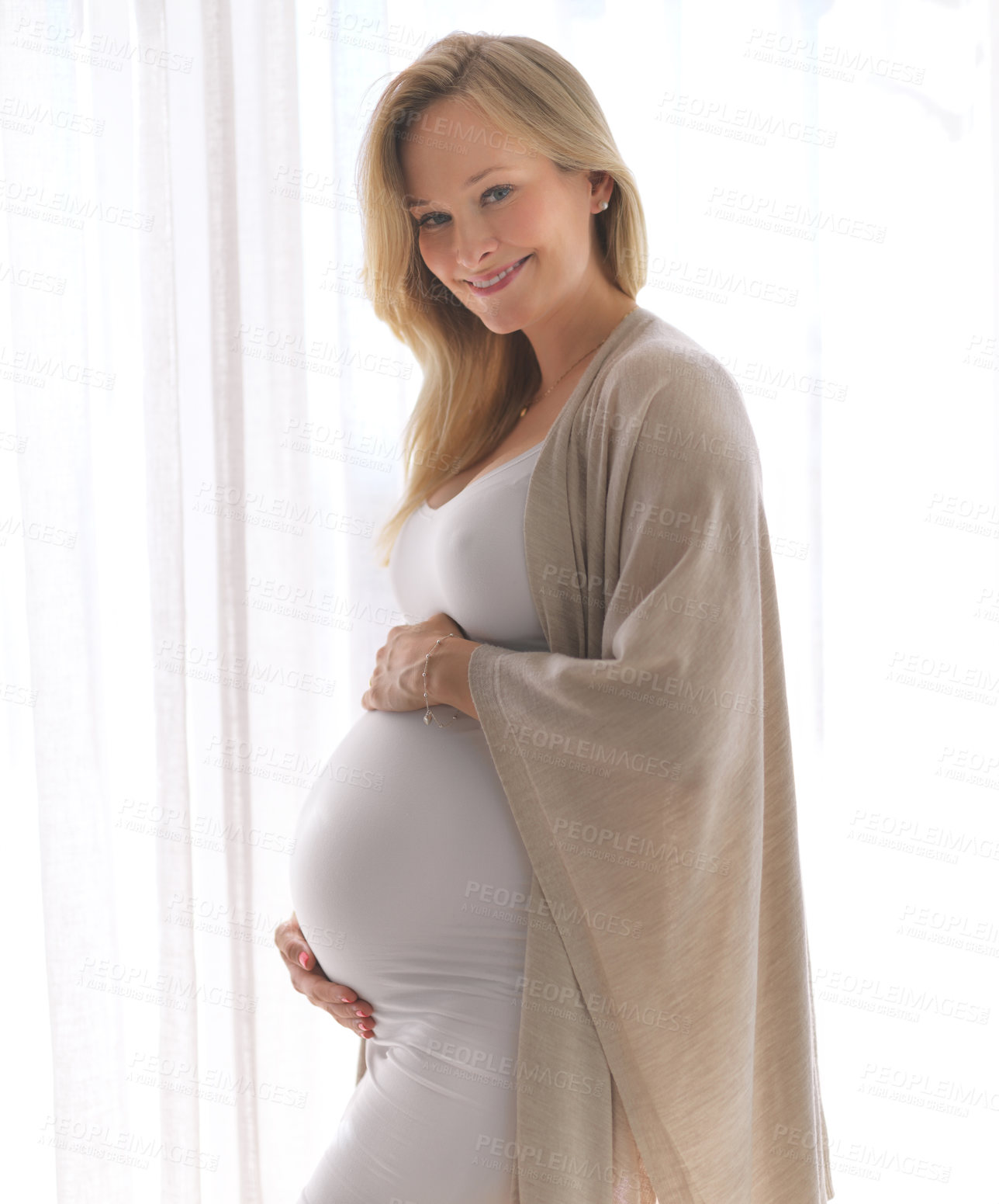 Buy stock photo Cropped portrait of a beautiful young pregnant woman standing in her home