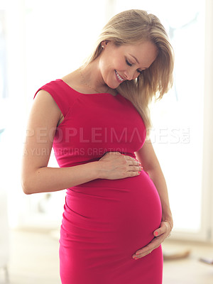 Buy stock photo Cropped shot of a beautiful young pregnant woman standing in her home