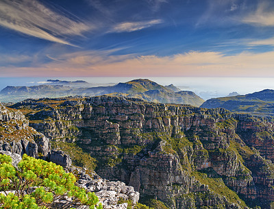 Buy stock photo Copy space with scenic landscape at the peak of Table Mountain in Cape Town with cloudy blue sky background. Breathtaking and magnificent views of the beauty in nature after a hike up a rocky region