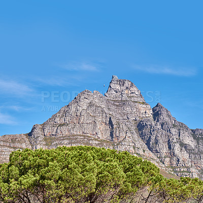 Buy stock photo Landscape view and blue sky with copy space of Table Mountain in Western Cape, South Africa. Steep scenic famous hiking and trekking terrain with trees growing around in. Cable car transport to peak