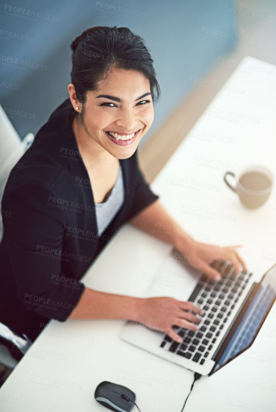 Buy stock photo High angle portrait of an attractive young businesswoman working on a laptop in her office