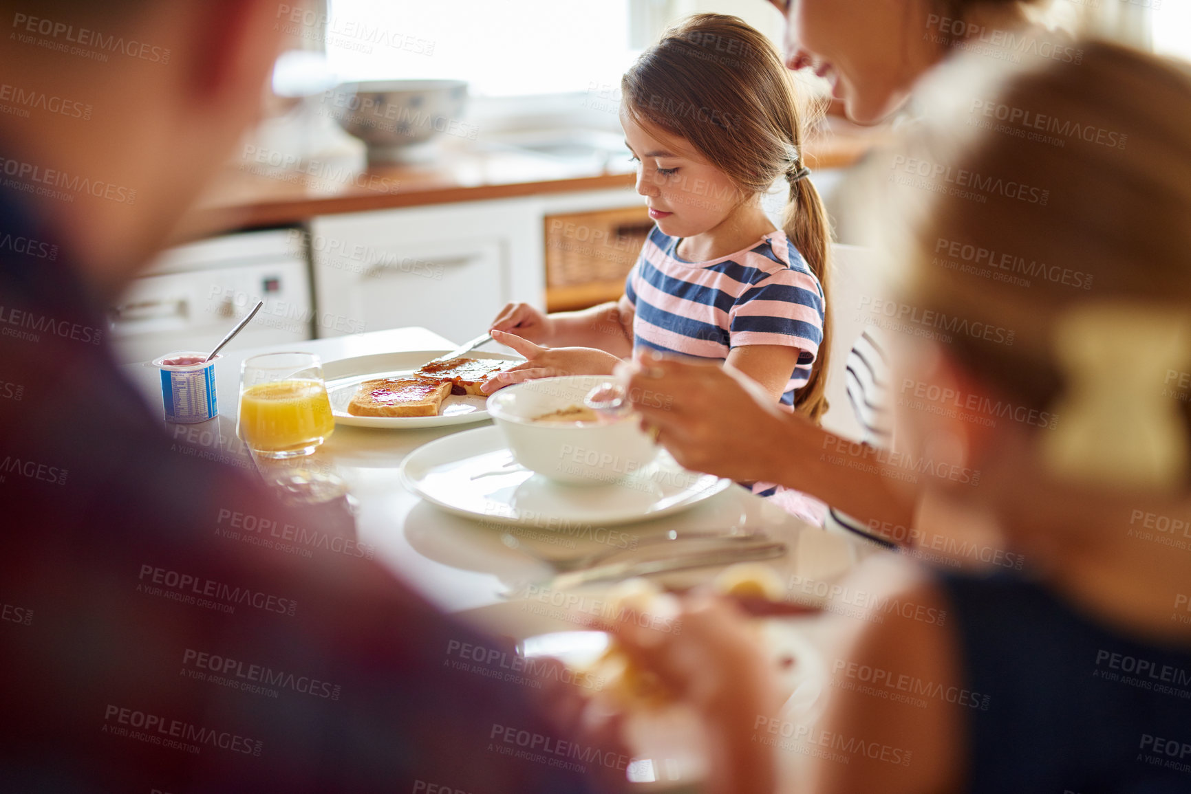 Buy stock photo Shot of a family having breakfast together