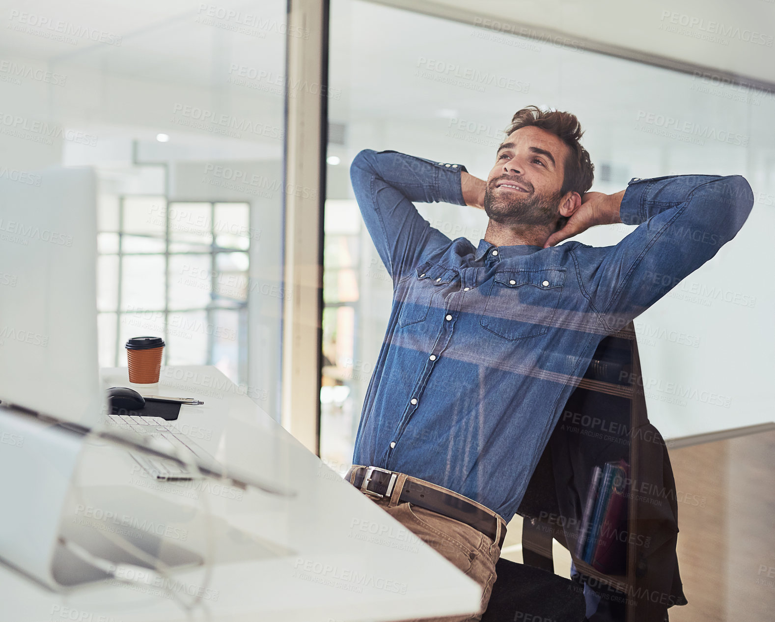 Buy stock photo Cropped shot of a handsome young businessman working in the office