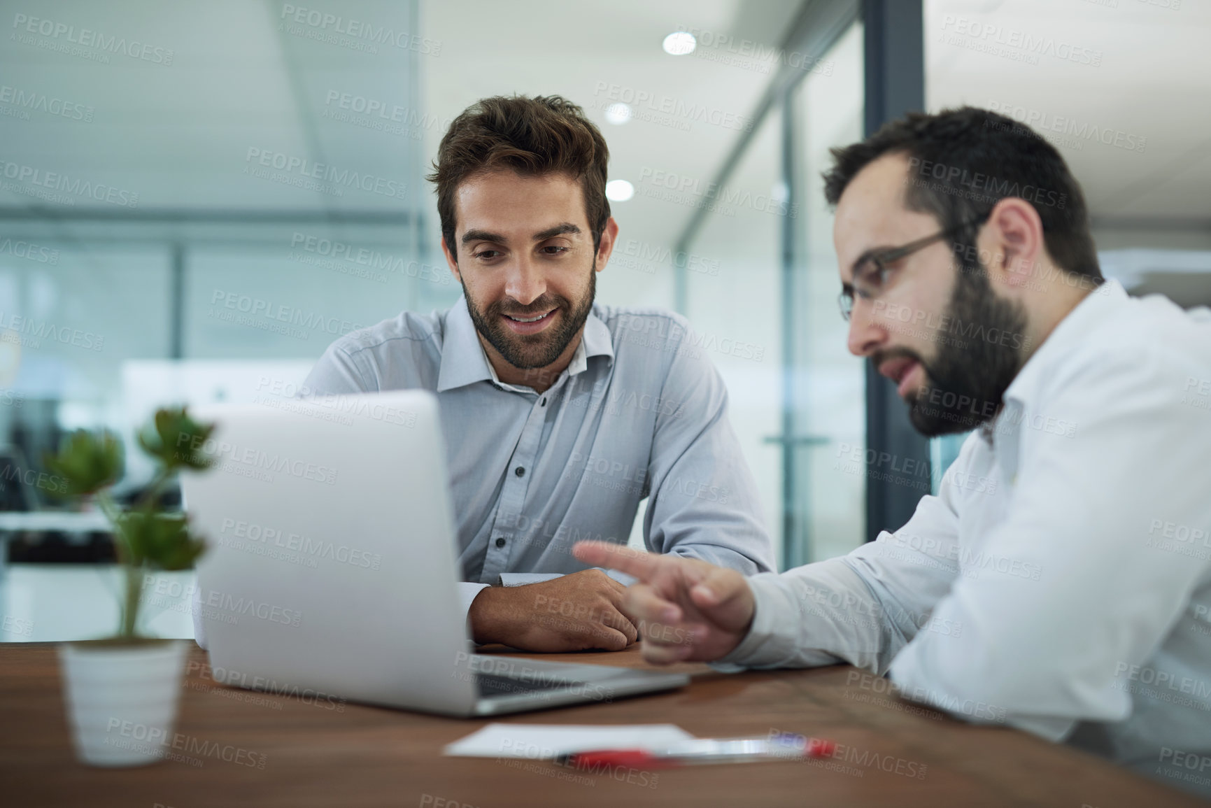 Buy stock photo Shot of two businessmen having a meeting in an office