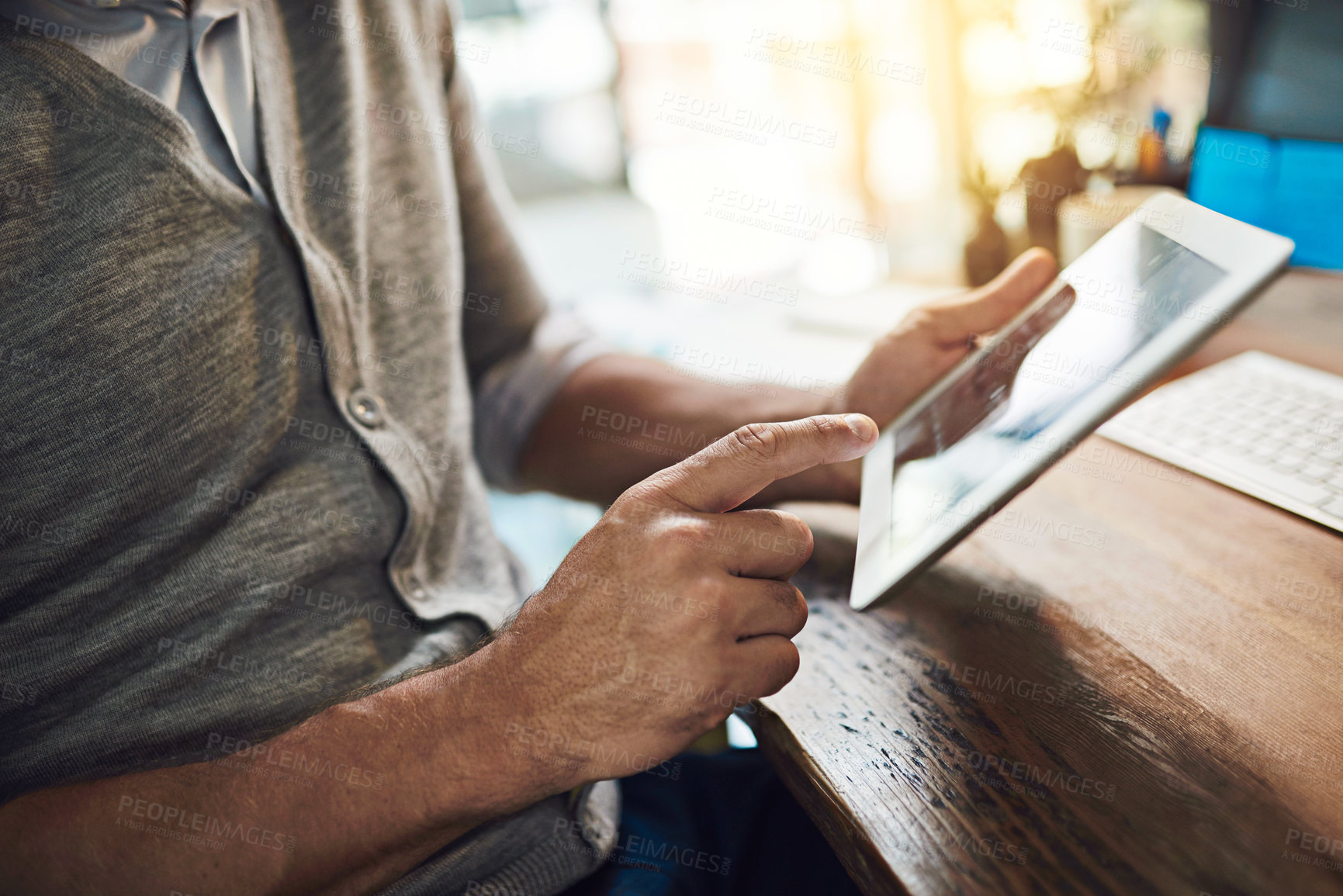 Buy stock photo Businessman, hands and touch with tablet for research, design or website at office desk. Closeup of man, designer or creative employee browsing or scrolling on technology for startup at workplace