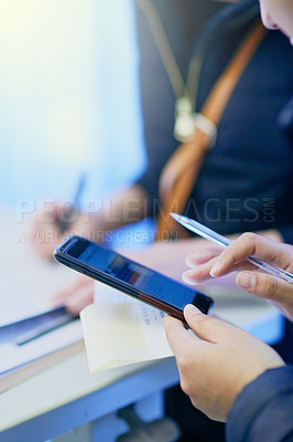 Buy stock photo Cropped shot of a doctor using a mobile phone