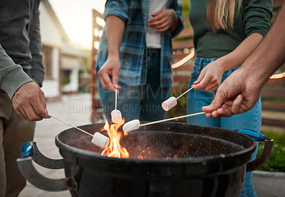 Buy stock photo Flame, hands and people roasting marshmallows in backyard for social event, gathering or hang out. Grill, fire and group of friends toasting, burning or melting sweet treat for smores snack outdoor.