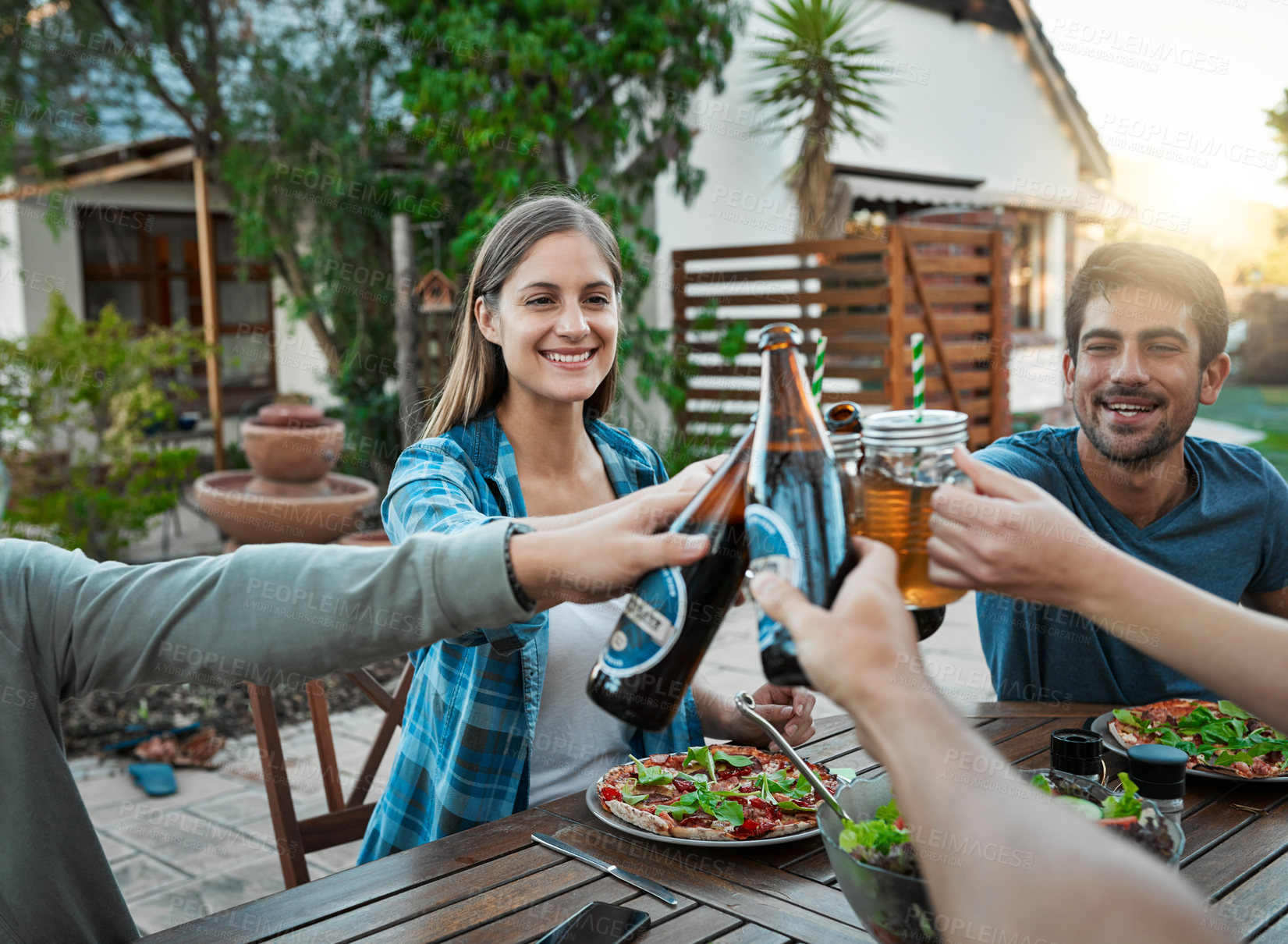 Buy stock photo Lunch, alcohol and people in garden for toast, celebration and connection for bonding together. Outdoor, smile and friends with beer bottle in social gathering, cheers or salad as food for nutrition