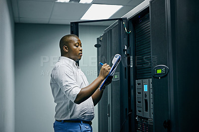 Buy stock photo Shot of an IT technician doing inspections in a data center