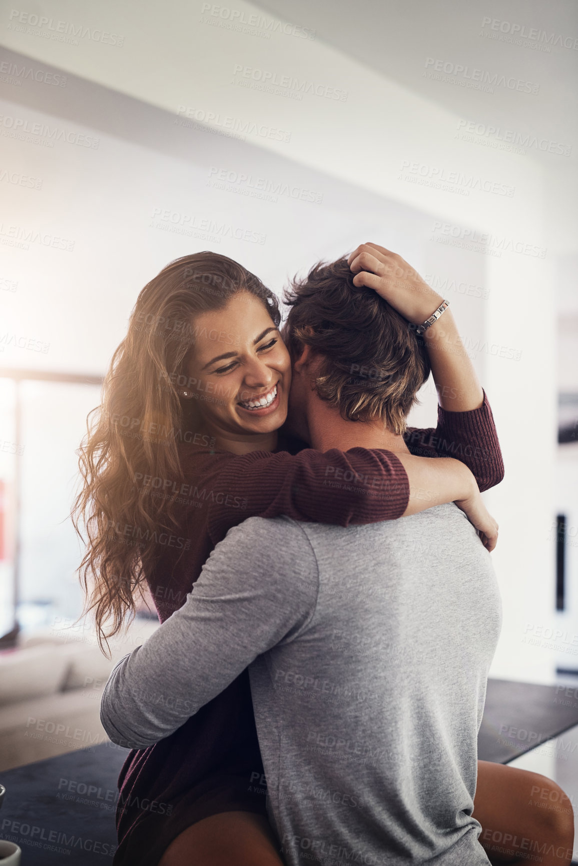 Buy stock photo Couple, hug and laughing in home on kitchen counter with love, bonding and smile together with joy. Embrace, romance and happy people with marriage with care, trust and commitment in house with fun