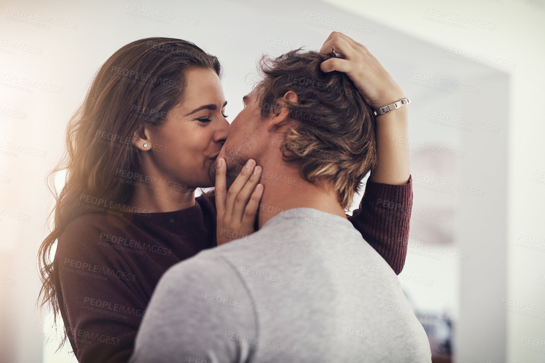 Buy stock photo Shot of a young couple making out in the kitchen