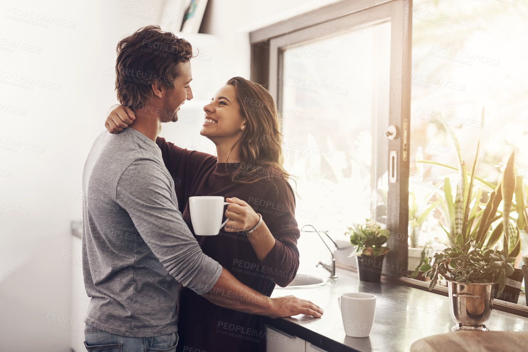 Buy stock photo Coffee, man and woman in kitchen with embrace, romance and bonding together in morning. Love, morning and happy couple hug with drink, connection and relax with relationship commitment at home