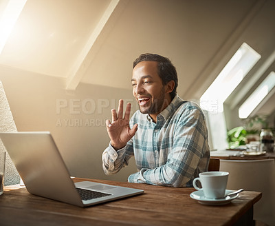 Buy stock photo Shot of a young man having a video chat on his laptop in a coffee shop